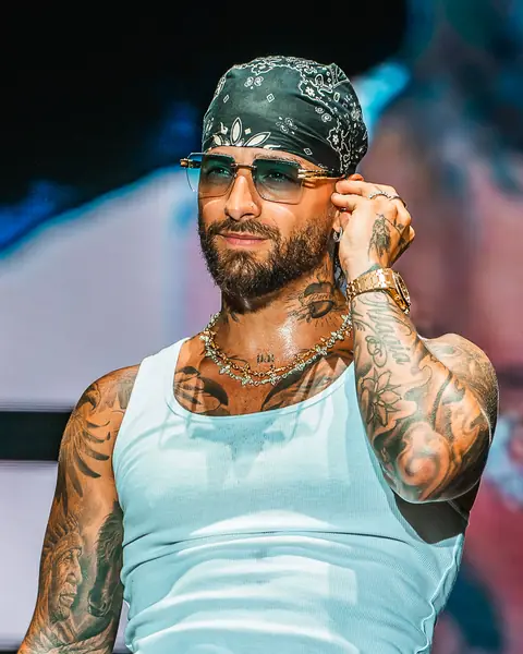 Maluma in a white vest and bandana on stage under blue light. Cook Music Fest, Tenerife, July 2024.
