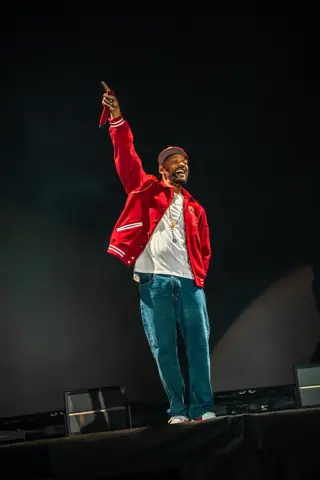 Will Smith in a red jacket points skyward from the stage. Granca Live Fest, Gran Canaria, July 2025. Photo for Why Agency.