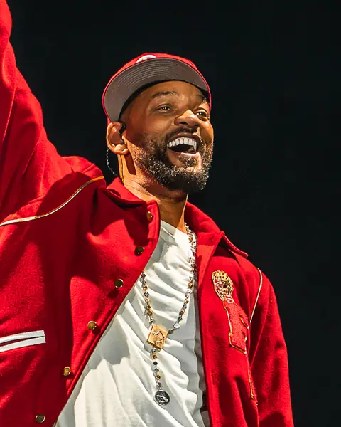 Will Smith in a red jacket points skyward from the stage. Granca Live Fest, Gran Canaria, July 2025. Photo for Why Agency.