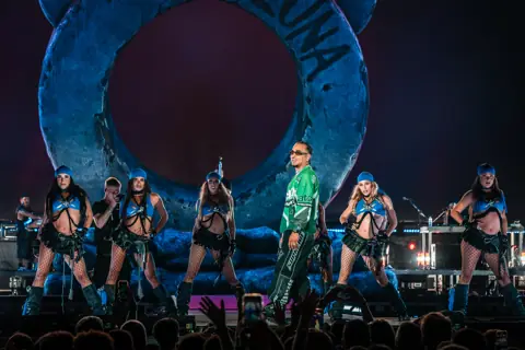 Ozuna surrounded by dancers in front of the giant bear head of his stage. Granca Live Fest, Gran Canaria, July 2025. Photo for Why Agency.