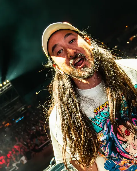 Steve Aoki, in a cap, looks at the camera from the booth. Lava Live, Lanzarote, July 2025. Photo for Why Agency.