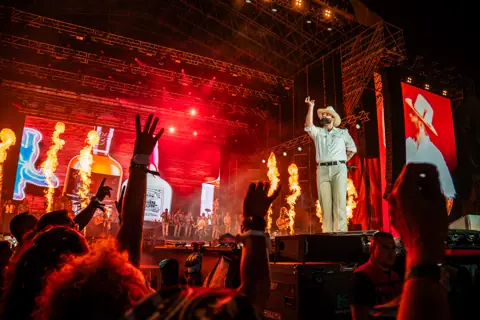 Carín León on stage amid flames and red light. Granca Live Fest, Gran Canaria, July 2025. Photo for Why Agency.