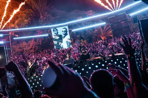 The Martinez Brothers in the MAPPA booth among palm trees and crowd. MAPPA 06 (Water), Tenerife, July 2026. Photo for Just Music.