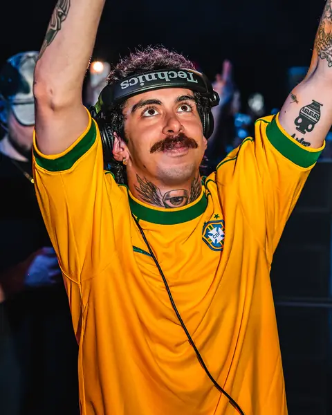 Mochakk in the Brazil jersey with arms raised in the booth. Sun Paradise Oasis, Tenerife, June 2024. Photo for Okidoki.