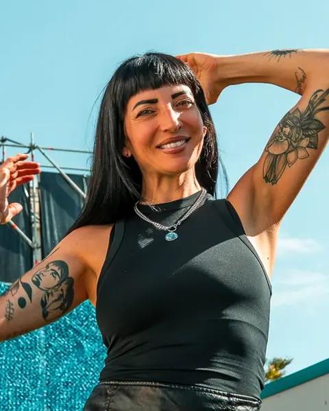 Juliet Fox posing backstage beside the stage in full sun. elrow Tenerife XXL, October 2025. Photo for Juliet Fox (DJ).